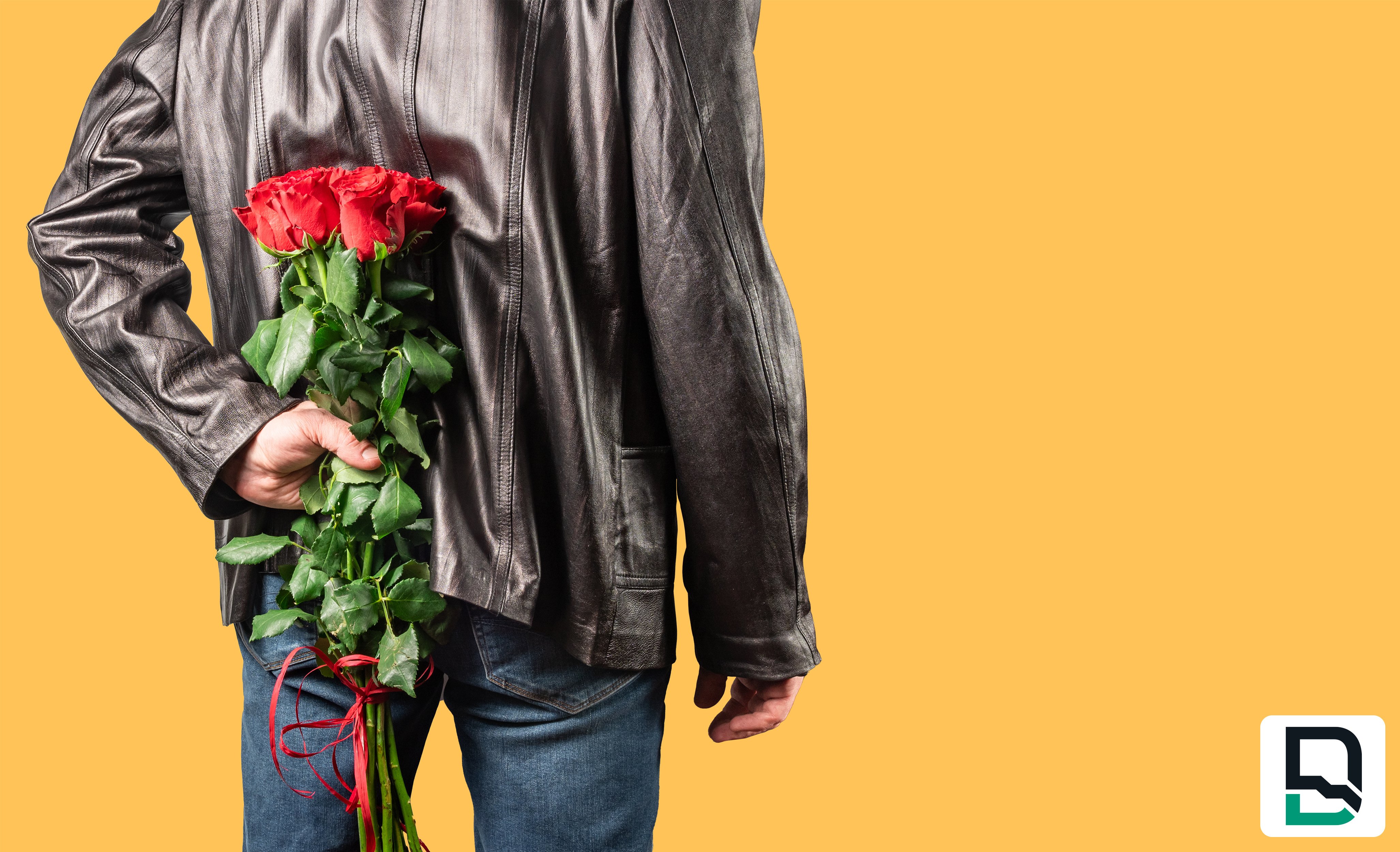 Man wearing leather jacket holding red roses behind his back