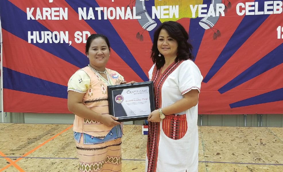Karen interpreter Htee Na receiving recognition for service