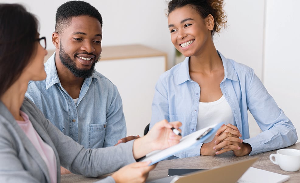 African American couple meeting with professional financial counselor